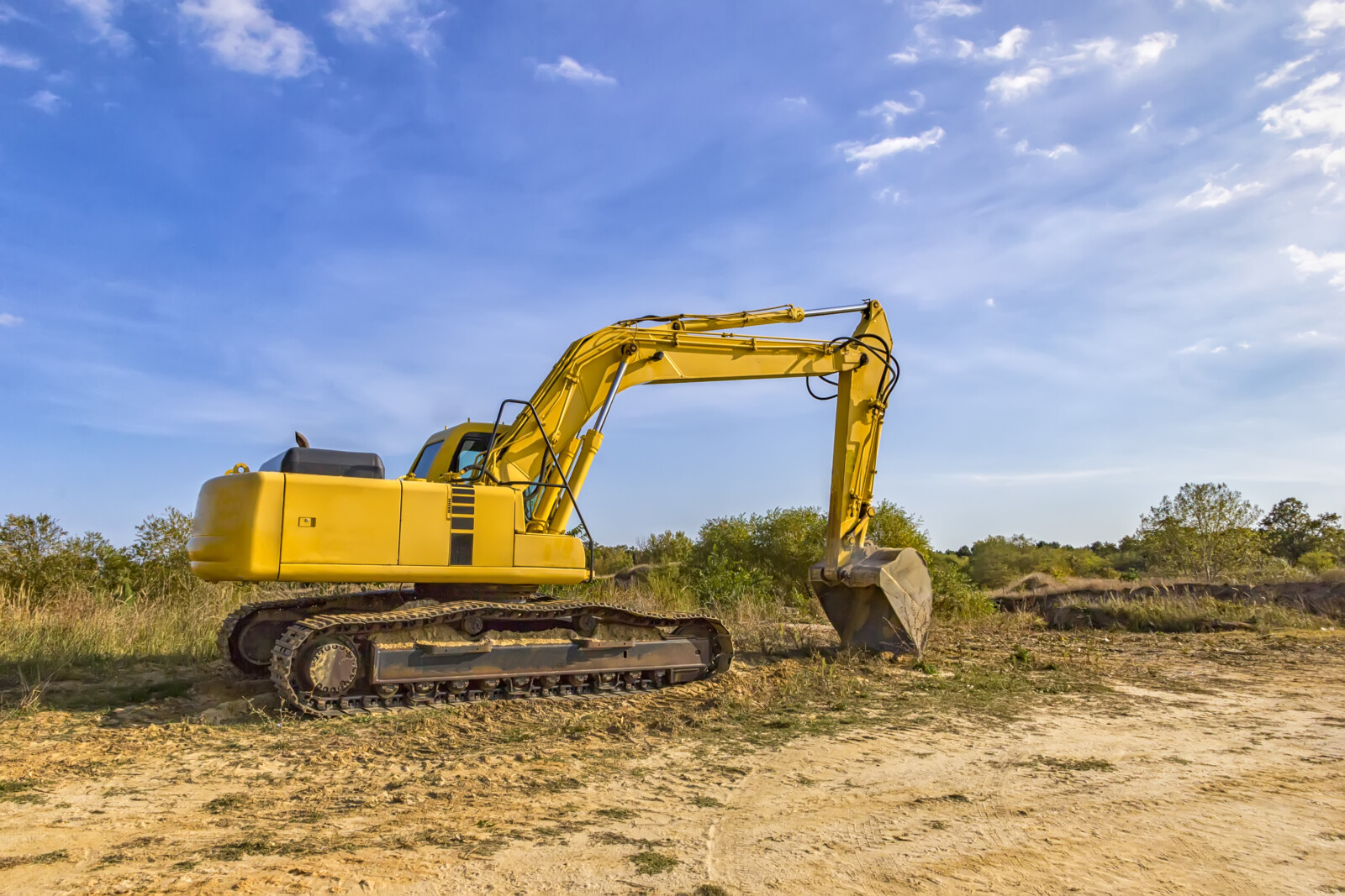 Large yellow excavator that may be too big for the current jobs and operating needs